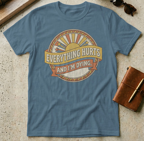Blue t-shirt with sunburst and text "Everything Hurts And I'm Dying".