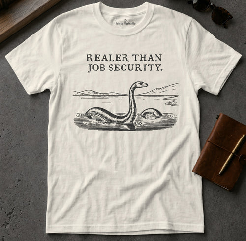 White t-shirt with "Realer Than Job Security" and Loch Ness Monster graphic.