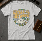 White t-shirt with retro graphic that reads "Expecting the worst" with a smiling cloud and umbrella.