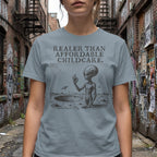 Gray t-shirt with alien graphic and text "REALER THAN AFFORDABLE CHILDCARE."