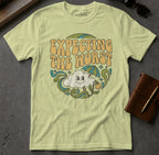 Light yellow t-shirt with "EXPECTING THE WORST" text and cartoon cloud.