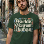 Green t-shirt with "World's Okayest Human" text in retro font.