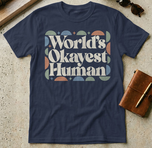 Navy t-shirt with "World's Okayest Human" text in retro geometric design.