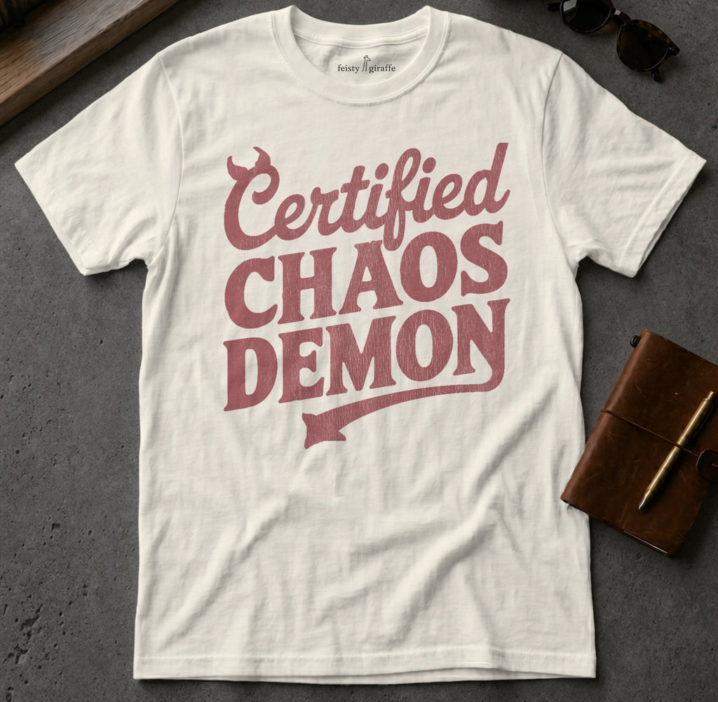 White t-shirt with "Certified Chaos Demon" text and a devil's tail graphic.