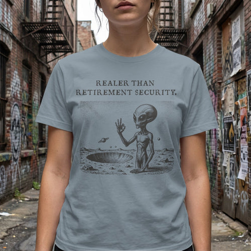 Grey t-shirt with alien on moon, text "REALER THAN RETIREMENT SECURITY."
