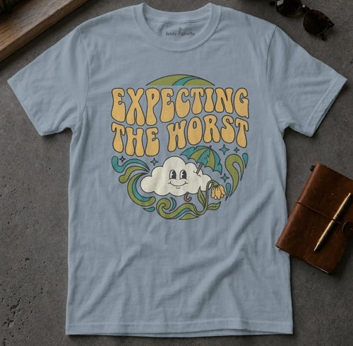 Light blue t-shirt with "Expecting the Worst" text and smiling cloud graphic.