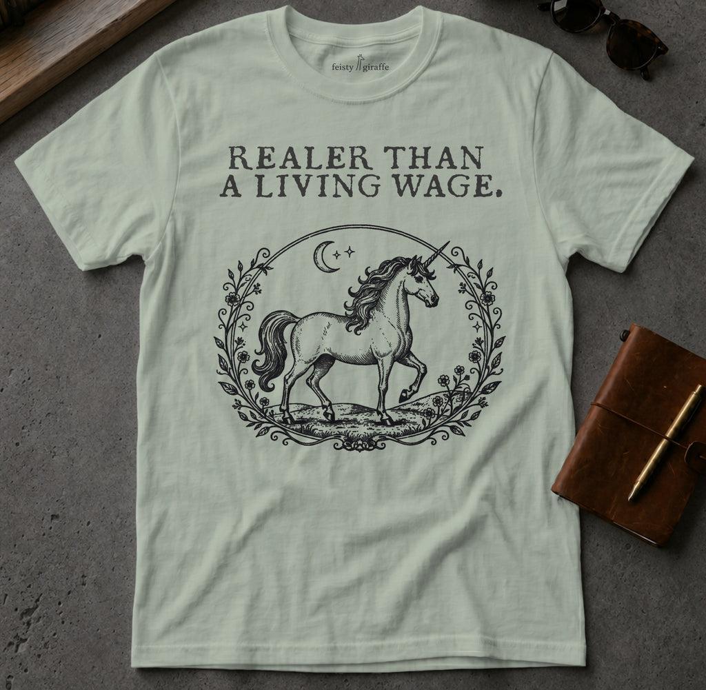 Light green t-shirt with unicorn illustration and text "REALER THAN A LIVING WAGE."