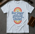 White t-shirt with "former gifted child" in colorful retro text.