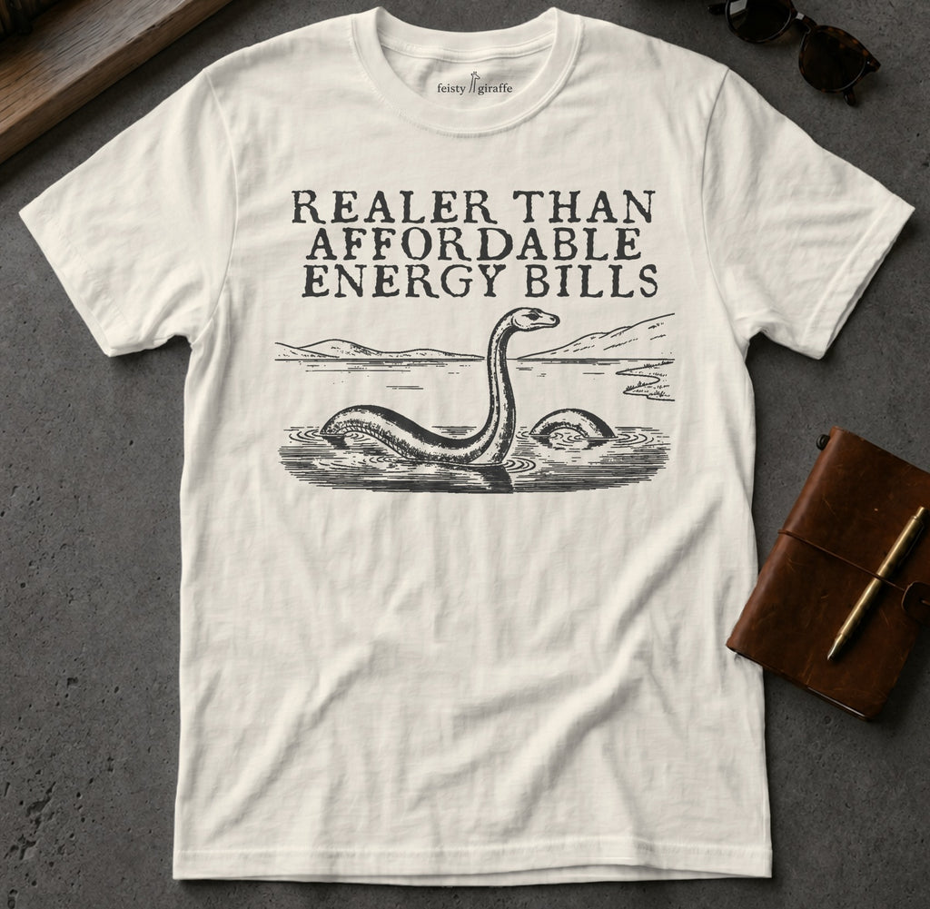 Cream t-shirt with "RealER THAN AFFORDABLE ENERGY BILLS" and a Loch Ness Monster graphic.