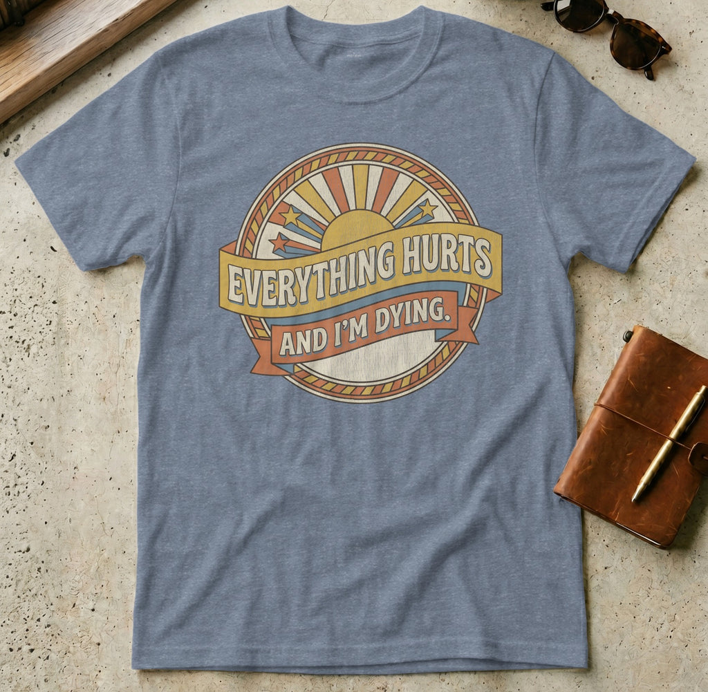 Blue t-shirt with "Everything Hurts And I'm Dying" text and sunburst graphic.